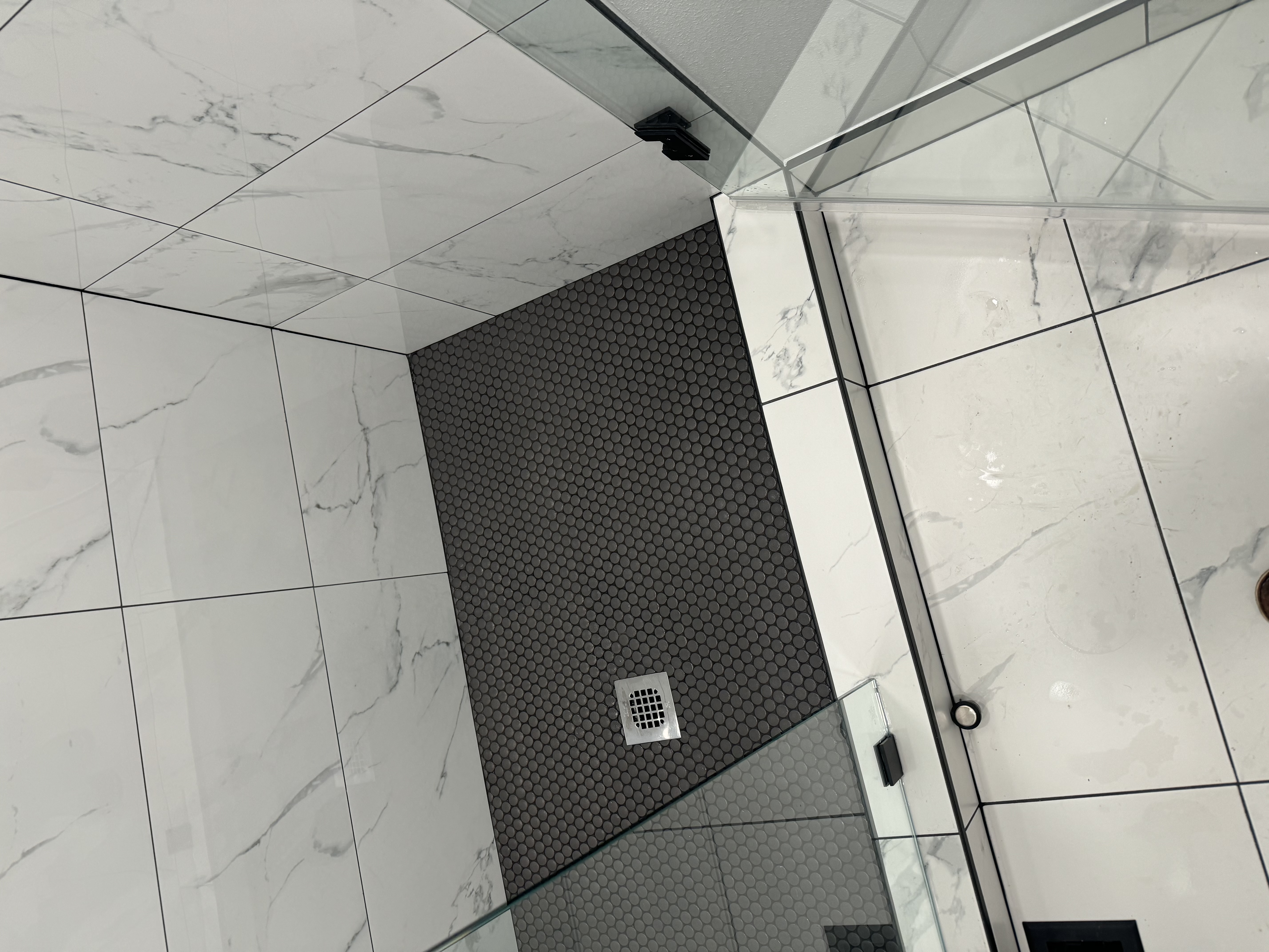 Marble Shower with Black Hexagon Floor
